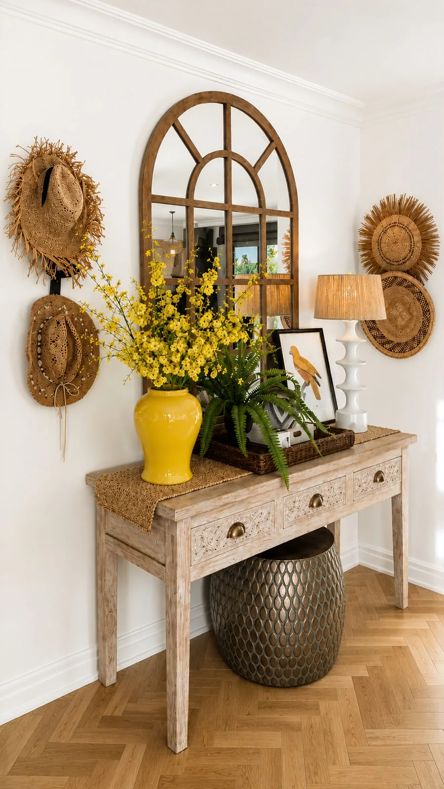 Pence House entrance hall — carved oak console, arched window mirror and a ginger jar of yellow blooms over herringbone parquet