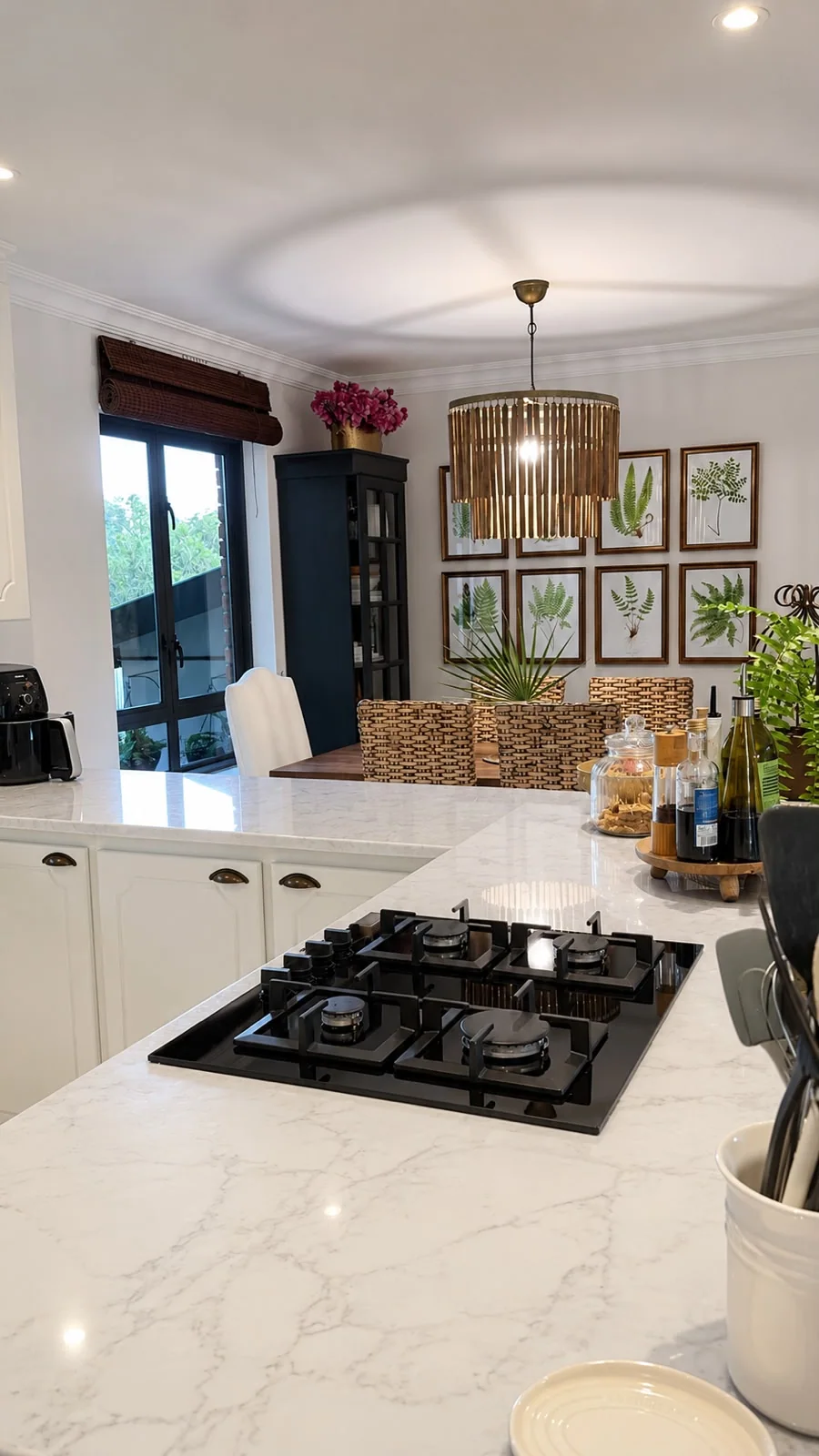 Pence House kitchen — shaker cabinetry and a marble waterfall island opening to the dining room